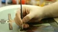 Iconography. Icon painter at work in icon painting workshop. Vídeos en HD
