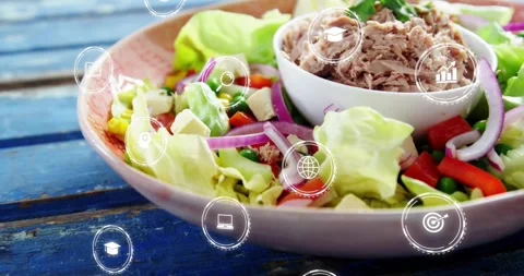Icons appearing over rim, camera moving into plate, revealing salad and Stock Footage 328346809