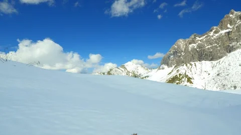 Icy Alpine Cliffs and Rolling Cloud Shadows Above Snowy Slopes near Rauheck i Stock Footage 308310804