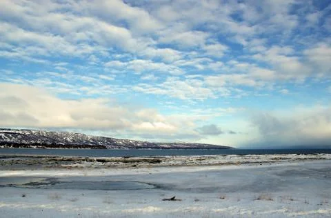 Icy bay with cloud patterns Stock Photos