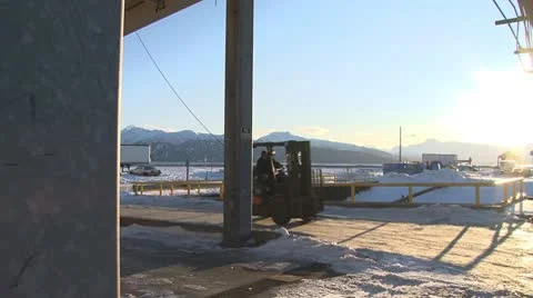 Icy Dock - Forklift Being Driven Past through Sun Flare Stock Footage 10685128