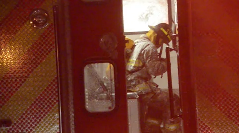 Icy Firefighter warming up after fire Stock Footage 35698000