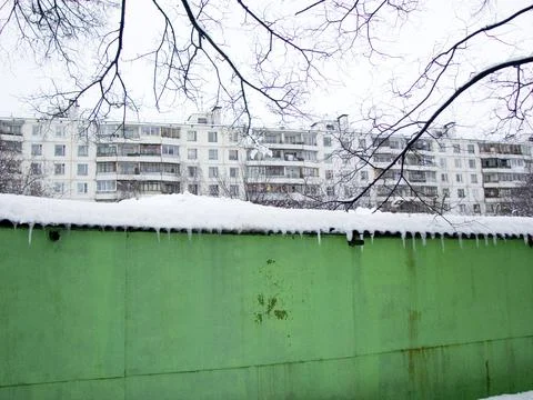 Icy green wall on the background of a multi-storey building Stock Photos