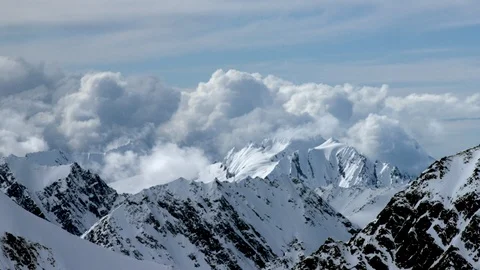 Icy high altitude mountains with cloudy winter sky background in day time Stock Footage 121577213