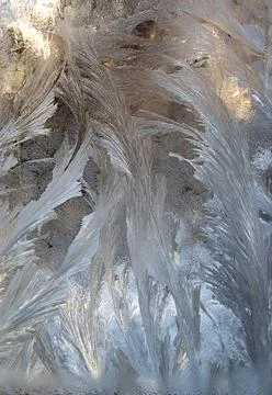 Icy patterns on the window glass in the winter. Stock Photos