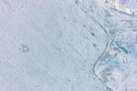 Icy snow texture on rough field surface, cold winter abstract background Stock Photos