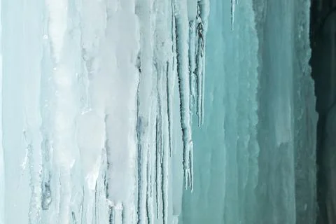 Icy winter background with icicles in the skylight Stock Photos