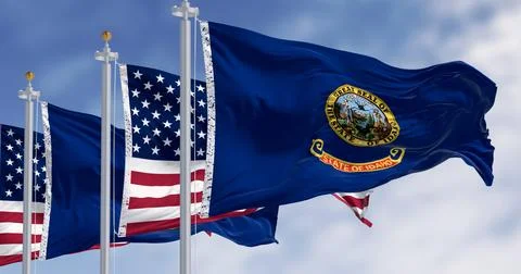 Idaho state flags waving along with the national flags of the US on a clear.. Stock Illustration