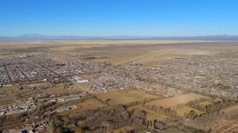 Ide drone glide over Malargüe, Argentina showing patchwork farmland, town edge Stock Footage 312592751
