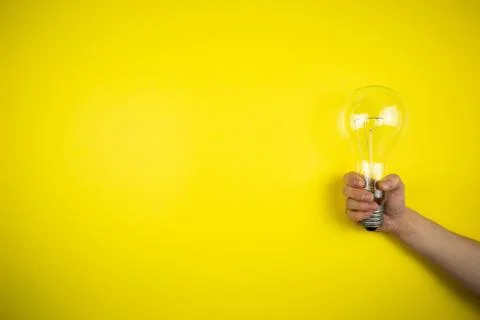 An idea came. Light bulb in hand Stock Photos
