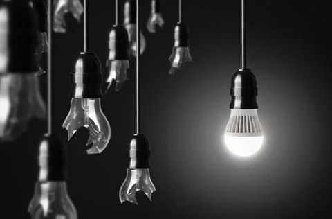 Idea concept with broken bulbs and one led glowing bulb Photos