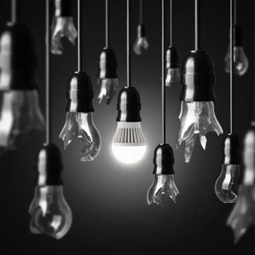 Idea concept with broken bulbs and one glowing led bulb Stock Photos