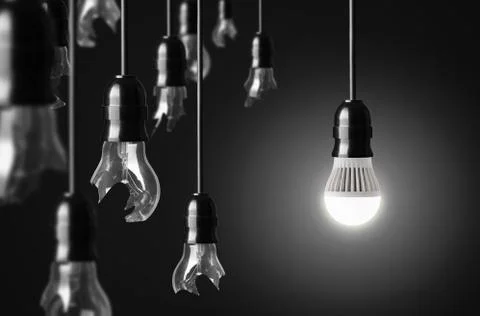 Idea concept with broken bulbs and one led glowing bulb Stock Photos