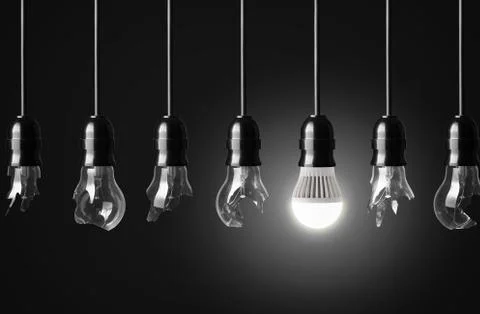 Idea concept with broken bulbs and one glowing led bulb Stock Photos