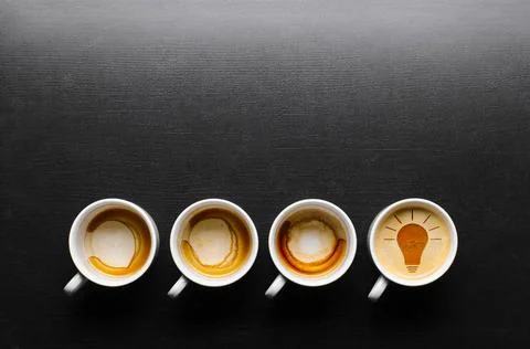 Idea concept idea. empty and full cups of fresh espresso with bulb sign, v... Stock Photos