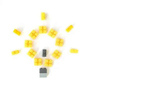 Idea concept. Lamp made of plastic constructor bricks on white background. Po Stock Photos