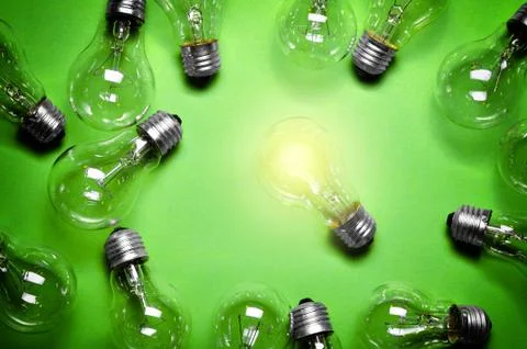Idea concept with light bulbs on green background. Stock Illustration