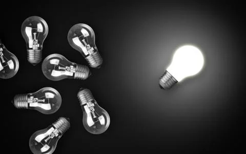 Idea concept with light bulbs, one of them is glowing. Stock Photos