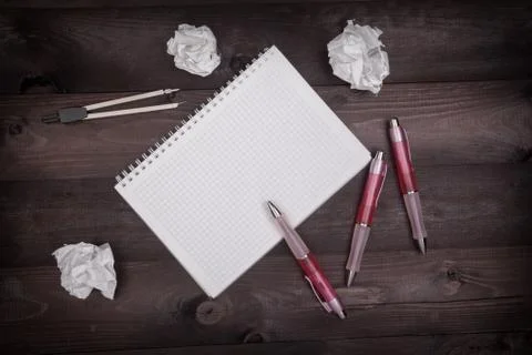Idea concept with pencils, notepad and crumpled paper on a black wooden table Stock Photos