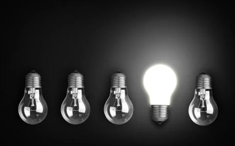 Idea concept with row of light bulbs, one of them is glowing. Stock Photos