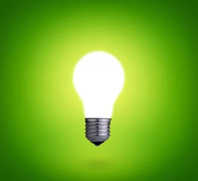Idea concept whit one glowing light bulb on green background Stock Photos