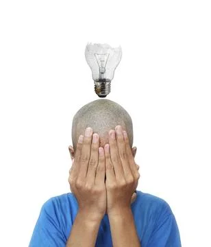 The idea of a man, with a glowing old broken light bulb in the middle Stock Photos