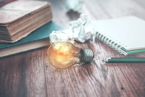 Idea on notepad with books Stock Photos
