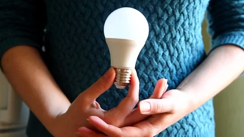 Idea or ecology concept, hands holding light bulb 動画素材 76375666