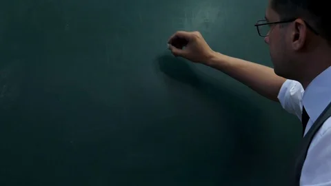 Idea, plan, action. The man in glasses is writing on the blackboard Stock Footage 90371608