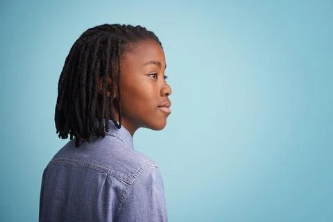 Idea, thinking and black boy kid in studio with why, questions or memory on blue Stockfoto's