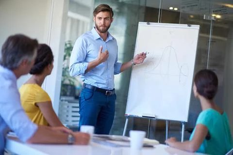 This idea WILL work. a handsome young man giving a business presentation. Foto stock