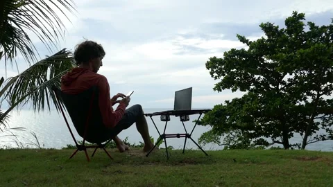 Ideal workplace for a freelancer in nature, man working on a laptop Stock Footage 293427768