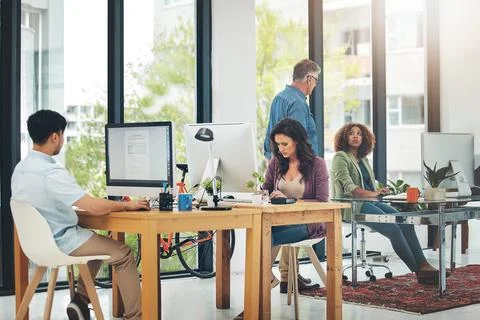 Ideas are easy implementation takes work. group of creative colleagues working Stock Photos