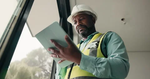 Ideas, black man and construction worker with tablet on site for feedback on Stock Footage 337922281