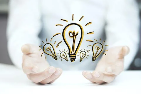 Ideas light bulb in a hand Stock Photos