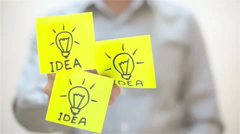 Ideas. A man sticks a note on transparent screen Stock Footage 67851116