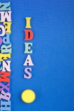IDEAS word on blue background composed from colorful abc alphabet block woo.. Stock Photos