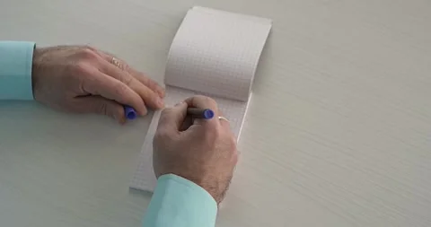 Ideea  - this word is written on the sheet by a man's hand Stock Footage 267083135