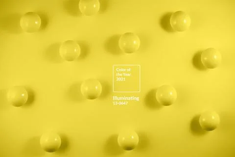 Identical balls on a yellow background Stock Photos