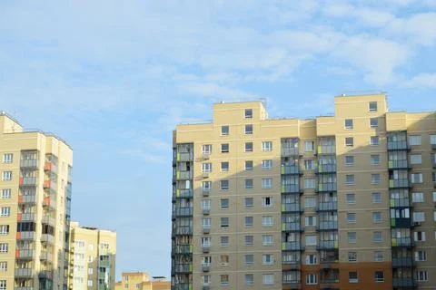 Identical high-rise buildings. Same type apartment buildings against a blue s Stock Photos