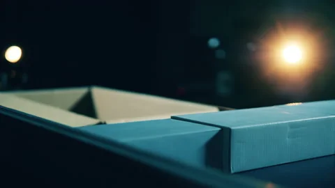 Identical parcels are getting transported by a robotic machine Stockbeeldmateriaal 143059243