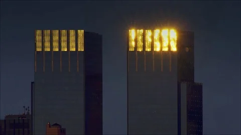 Identical skyscrapers reflect the setting sun off. Stock Footage 78810024