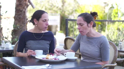 Identical twins sitting in a cafe, drinking coffee Stock-Footage 58609670