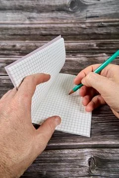 Identifiable hand writing on a notepad. Stock Photos