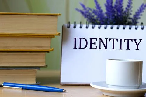IDENTITY - word in a notebook on a background of old books with pen and white Stock Photos