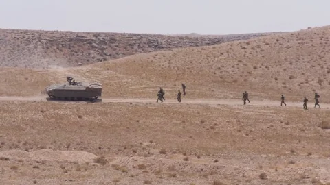IDF ADF driving forward, soldiers walk behind it. 스톡 동영상 168536759