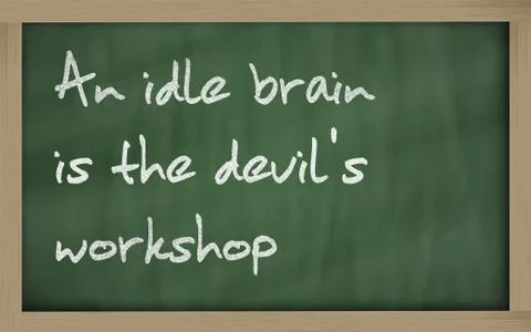 " an idle brain is the devil's workshop " written on a blackboard Stock Photos