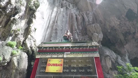 Idumban statue at limestone cliff wall inside Temple cave, Batu caves Stock Footage 196383184