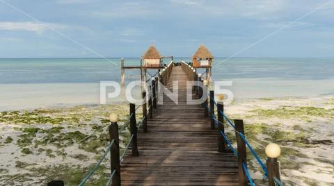 Idylic bamboo huts in the blue ocean Stock Photos