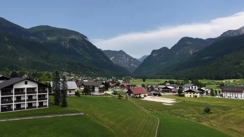 Idyllic alpine village nestled in a green mountain valley Video stock 318961053